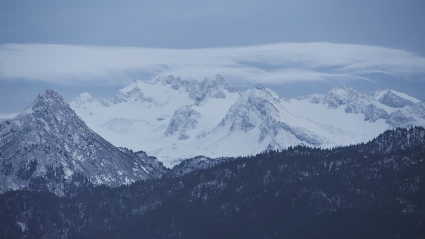 Cloud time lapse of the snowy peaks of the Kenai Mountains over Kachemak Bay,