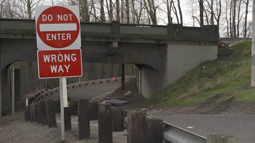 Street Scene of Wrong Way Sign with Bridge