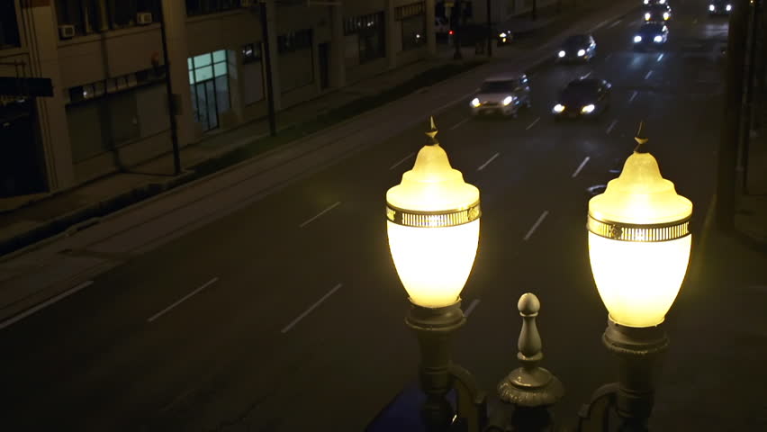 Looking down on nighttime traffic in Portland, Orego with Art Deco street lamp