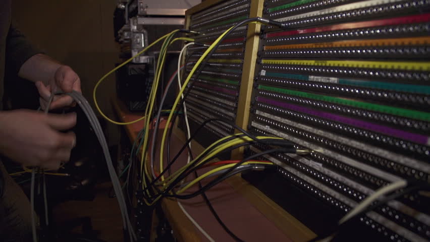 Close-up of an engineer's hands setting mix in sound recording studio.