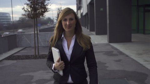 SLOW MOTION: Businesswoman walking towards camera