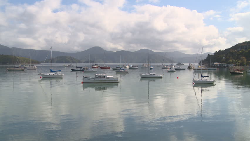 Sailboats at anchor in a tranquil bay
