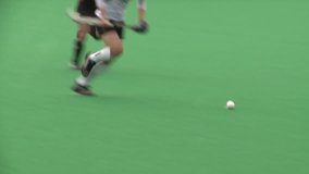 Field Hockey played on astro turf. woman's field hockey played on a rainy day in London. - Powered by Shutterstock - Get 15% off with code: PIKWIZARD15
