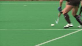 Field Hockey played on astro turf. woman's field hockey played on a rainy day in London. - Powered by Shutterstock - Get 15% off with code: PIKWIZARD15