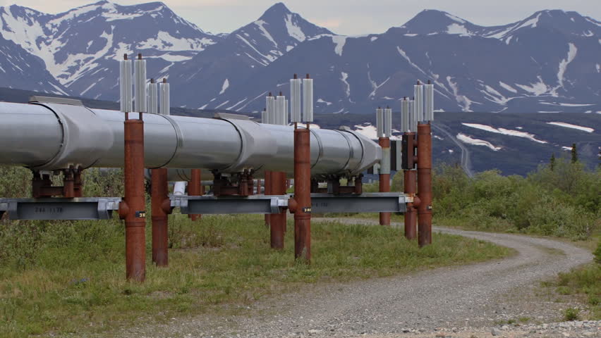 Trans-Alaskan Pipeline snaking up a far-off hill toward distant mountains