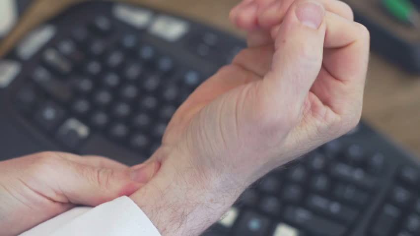 Carpal Tunnel Syndrome in office: massaging sore wrists