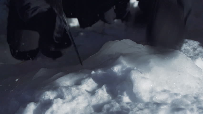 Mountain climber uses ice pick to climb frozen mountain 