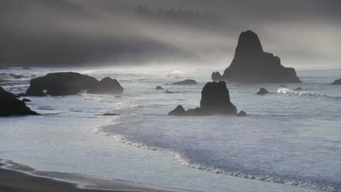 Waves rolling into the misty beach at Port Orford, Oregon