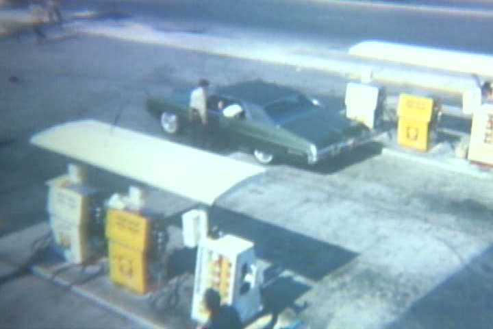 1960s - A father and daughter go to a gas station in the 1960s.