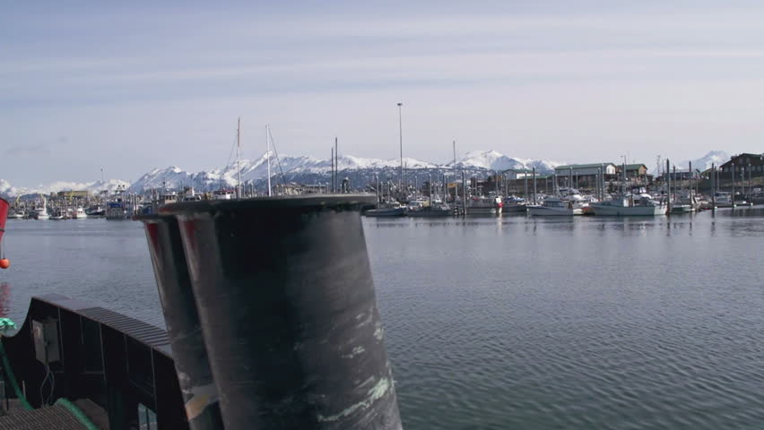 Moored tug boats in Homer Harbor, Alaska reveal small industrial boat