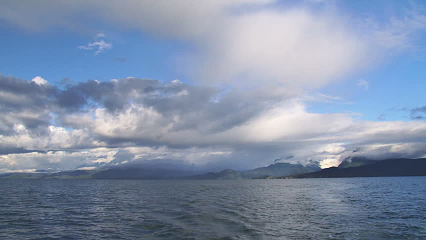 Handheld view looking after from moving boat looking across Kachemak Bay, Alaska