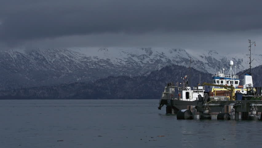 HOMER, ALASKA - OCTOBER, 2012 - A tugboat tows a CISPRI (Cook Inlet Spill