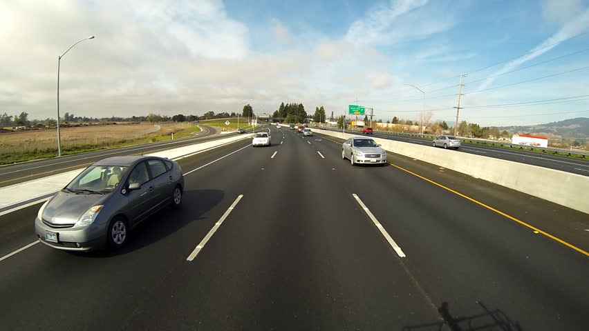 SANTA ROSA, CA - FEBRUARY 2013 - Cars pass freeway traffic driving on Highway
