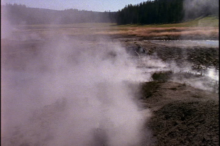 Steam rising from hot springs within Yellowstone National Park in Wyoming.