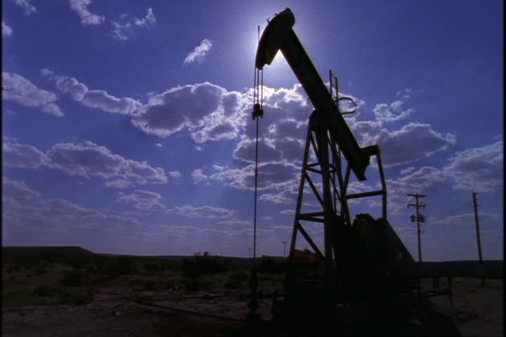 Silhouette of a working oil well pump jack on the plains in Yellowstone National park, Wyoming.