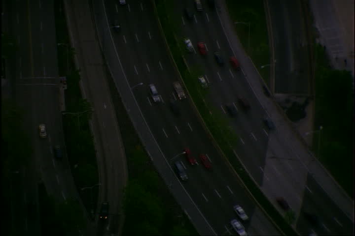 High angle view of highway along Lake Michigan, tilt up to show skyscrapers, coastline and lake in Chicago, Illinois.