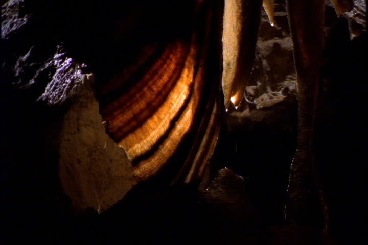 Water drops drip from stalactite near the curtain formation in Wolverine Cave in Yorkshire, England.