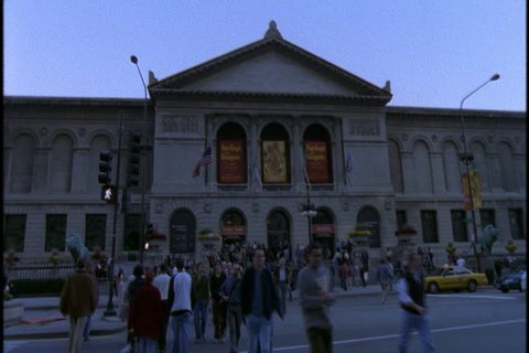 CHICAGO - NOVEMBER 03, 2001: Crowds of pedestrians walking in front of the Chicago Art Institute, zoom slowly to signs for Van Gogh exhibition.