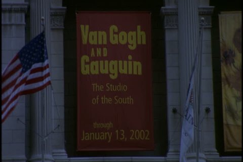 CHICAGO - NOVEMBER 03, 2001: Tilt down from banner advertising Van Gogh and Gauguin exhibit to people entering and exiting the Chicago Art Institute.