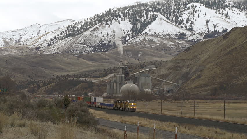 EASTERN OREGON, USA - MARCH 2013 - Freight train passes an industrial facility