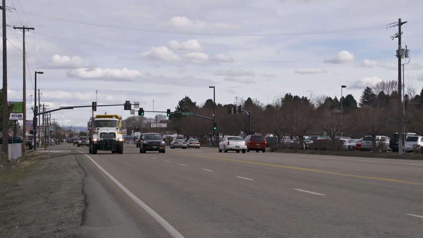 BOISE, ID - MARCH 2013 - Various cars and dump truck pass intersection on