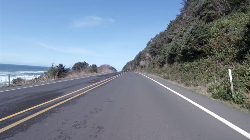 YACHATS, OR - UNKNOWN - Oncoming traffic drives south along the ocean on a sunny