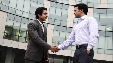 Shaky shot of two businessmen shaking hands