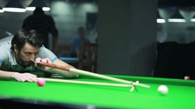 Young man playing billiard (snooker)/Snooker player