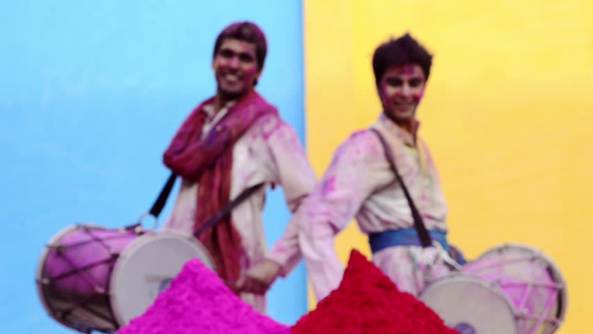 Rack focus shot of two male friends playing dhol during holi festival | Shutterstock HD Video #4333259