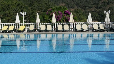 The swimming pool sunbeds and flowers at luxury hotel, Fethiye, Turkey