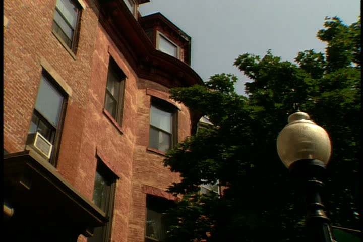 Low angle view of brownstone apartment building and street lamp in Boston, Massachusetts.