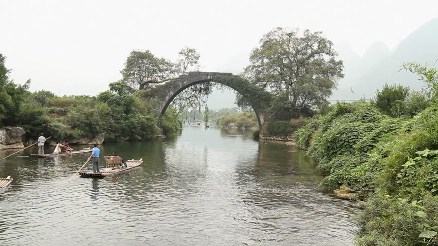 YANGSHUO, GUANGXI, CHINA - OCTOBER 21: Bamboo raft on Yulong river with ancient
