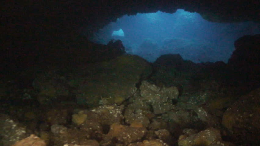 scuba divers in cave
