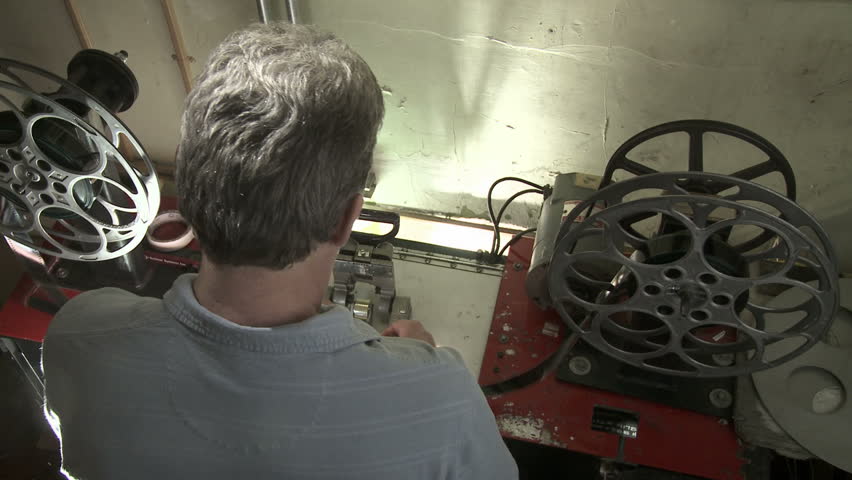 Projectionist inspects a 35mm film print.
