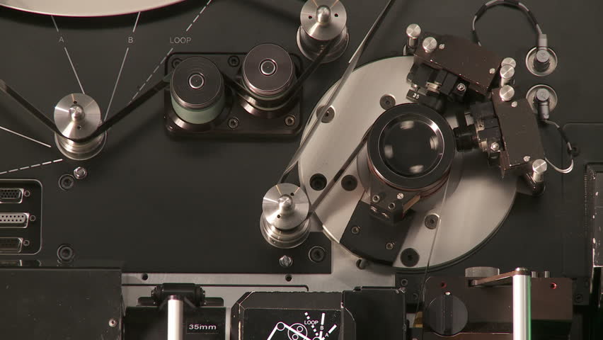 Detail of 35mm film running at 24 frames per second through a telecine machine. 