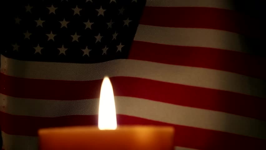 American flag and candle burning.