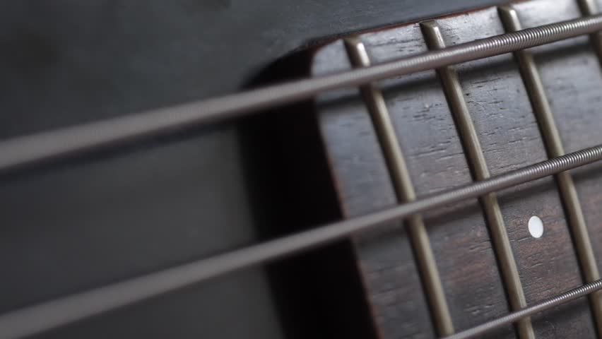 Close up of bass guitar string vibrating