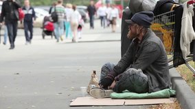 Beggar sitting in the street waiting for coins