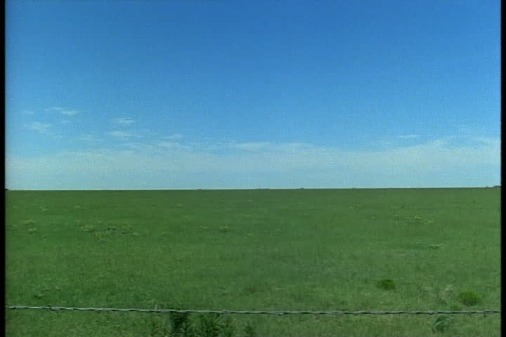 Flat grassy plain and big blue sky in Oklahoma Panhandle, Oklahoma.