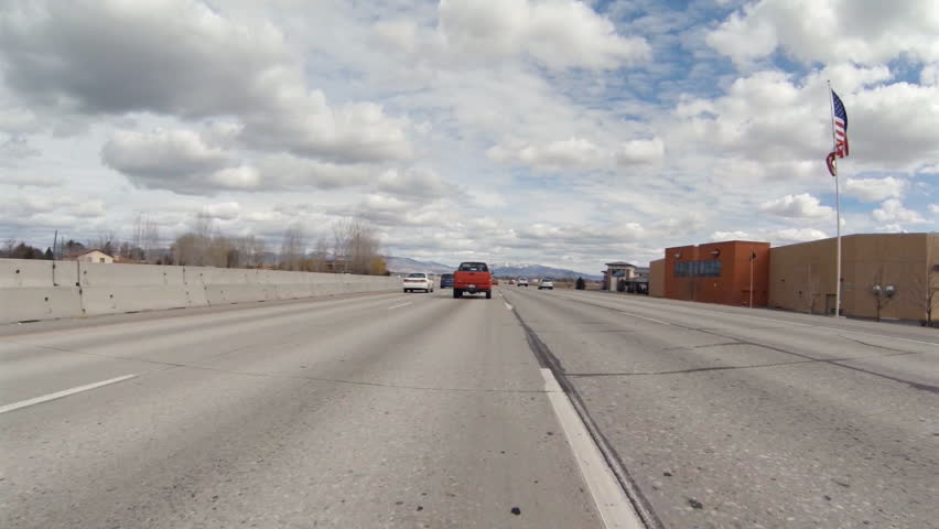 BOISE, ID - MARCH 2013 - Driving POV passes red truck on freeway in March, 2013