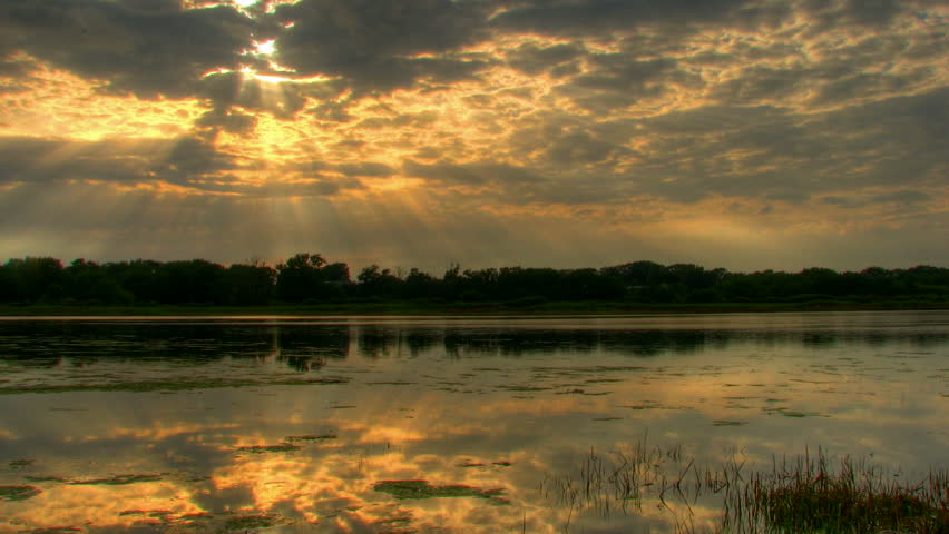 Sun beams over lake at sunset, HD time lapse clip, high dynamic range imaging