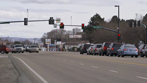 Boise, ID - MARCH 2013 - A police cruiser passes stopped traffic at an intersection to respond to a call on a cloudy afternoon in March, 2013 in Boise, Idaho