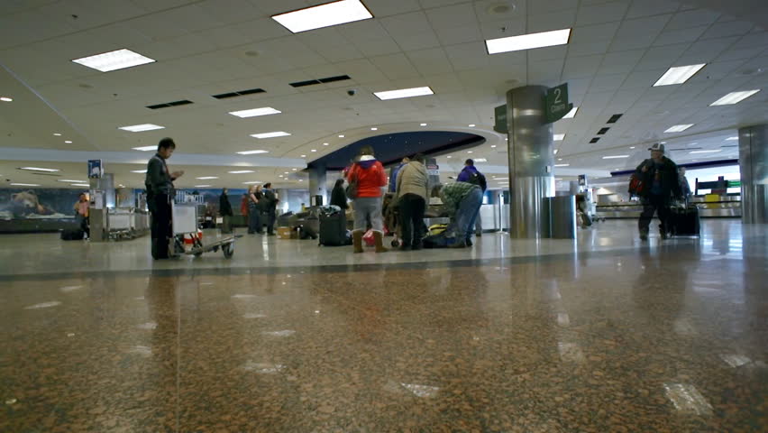 ANCHORAGE, AK  Time lapse of people collecting luggage at baggage carousel in an