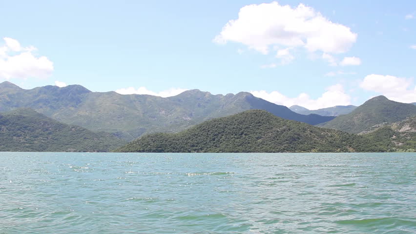 the view from a boat floating on the lake and the mountains - Lake 