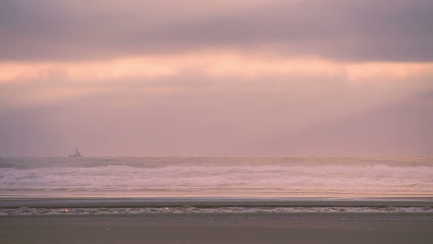 A small fishing trawler bobs along the coast of Oregon during a lovely sunset