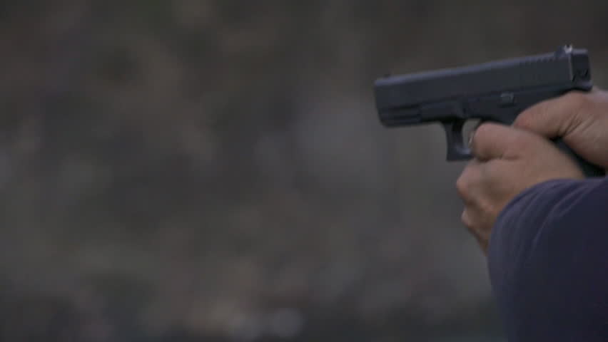 View from left of a man firing a Glock handgun repeatedly, with visible muzzle
