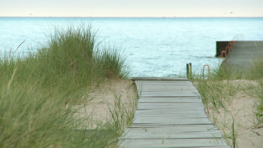 Early morning view along a boardwalk, past sand dunes, to Lake Michigan, USA. 