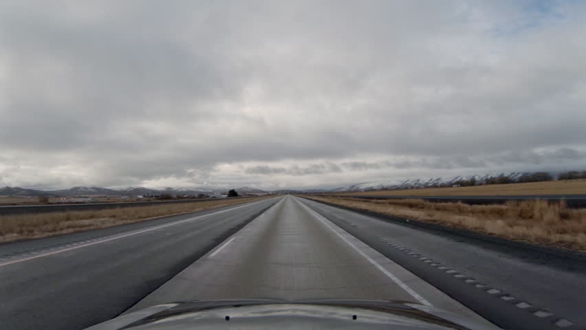 Driving on highway 84 towards Boise, Idaho in Oregon under threatening clouds pov
