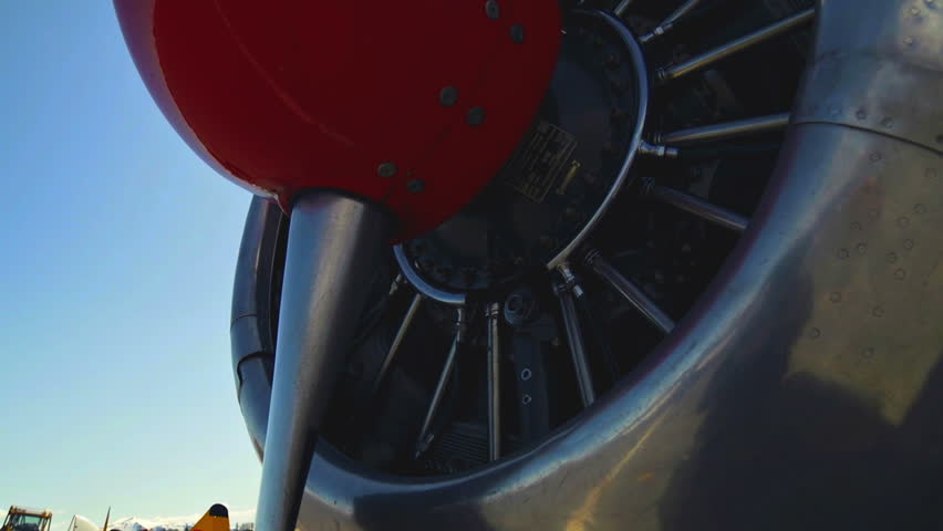 Propeller and engine of a vintage old fighter plane with sunburst
