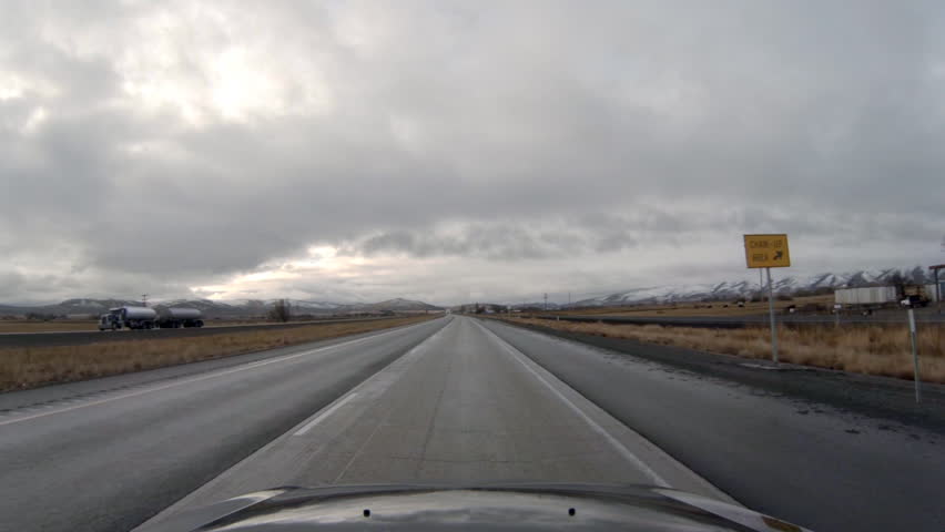 Driving view into overcast, stormy conditions on Interstate 84 in Oregon headed